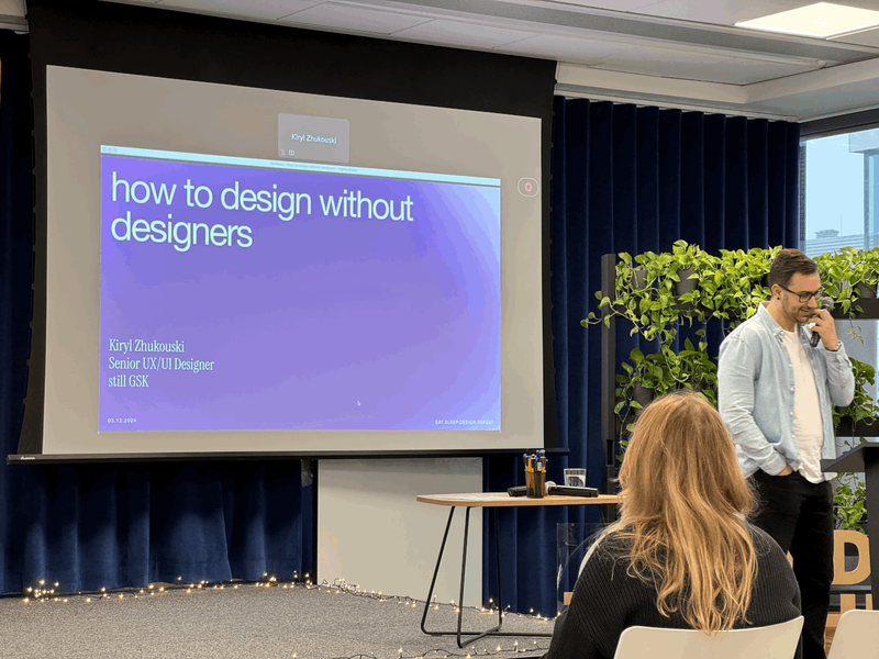 Kiryl opening How to design without designers in front of an audience at GSK